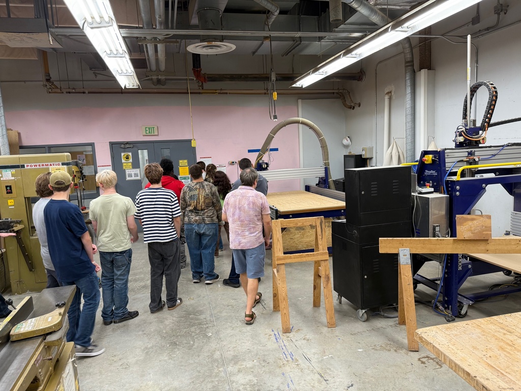 Students looking at the engraving machine