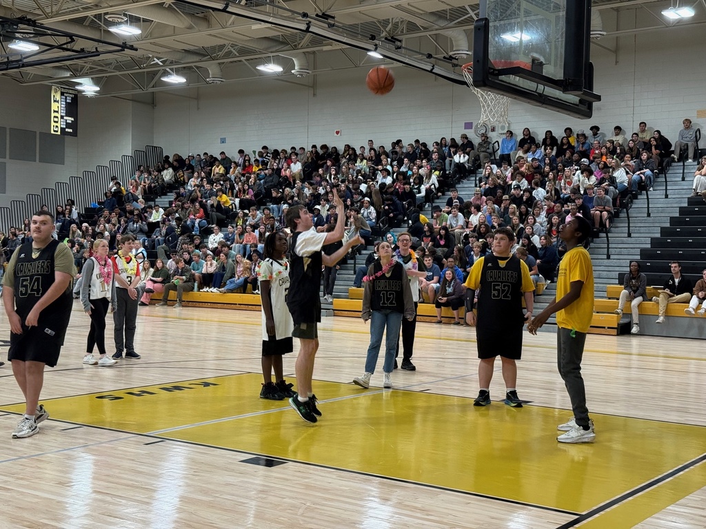 Players at the game taking a shot at the hoop