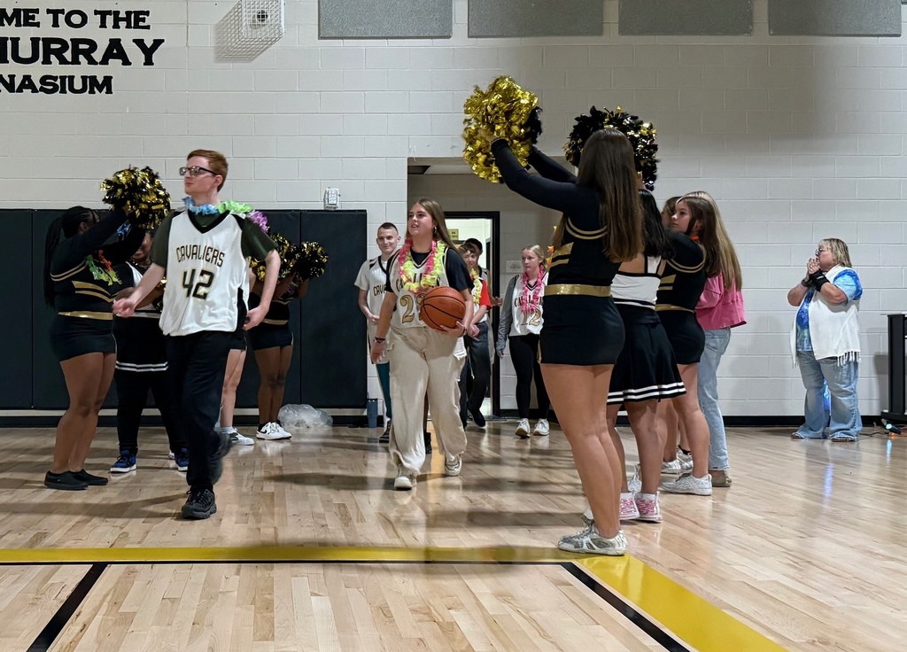 Players at the intro of the game entering with cheerleaders cheering