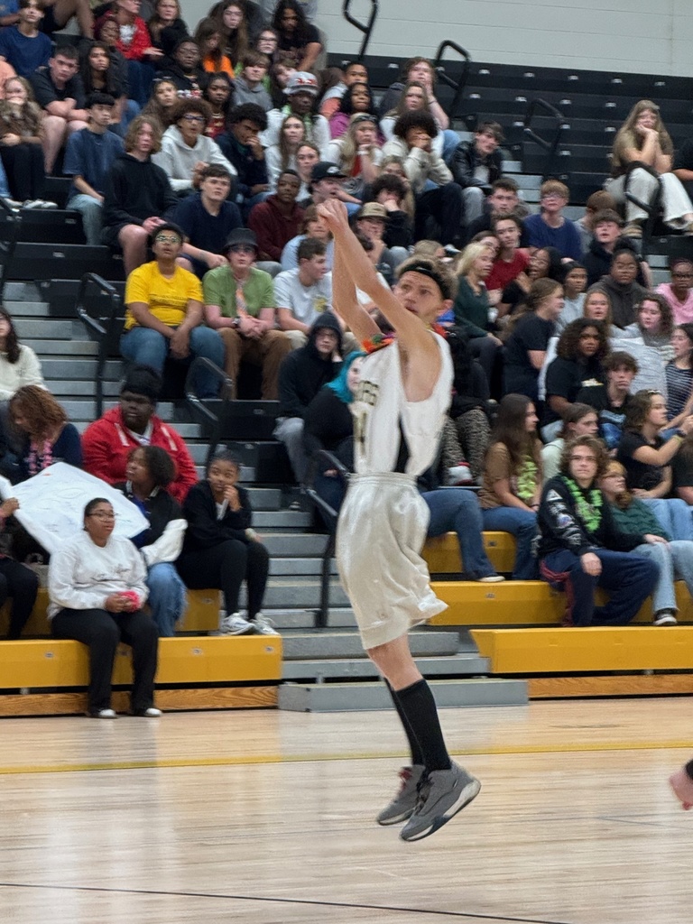 Players at the game taking a shot at the hoop