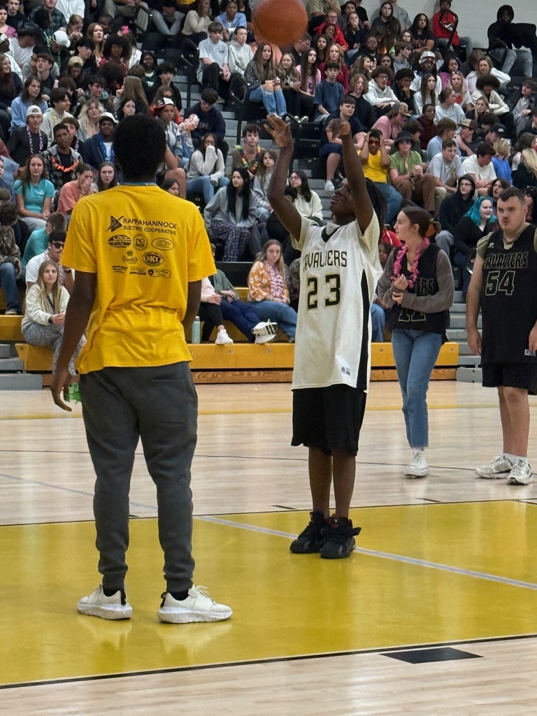 Players at the game taking a shot at the hoop