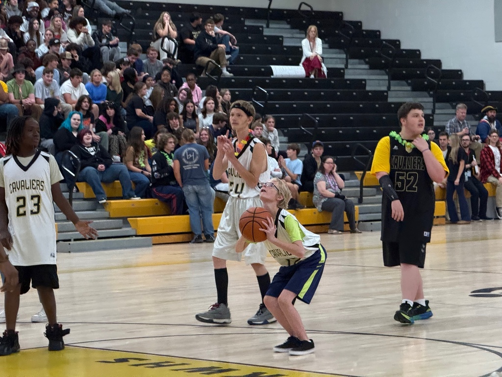 Players at the game taking a shot at the hoop