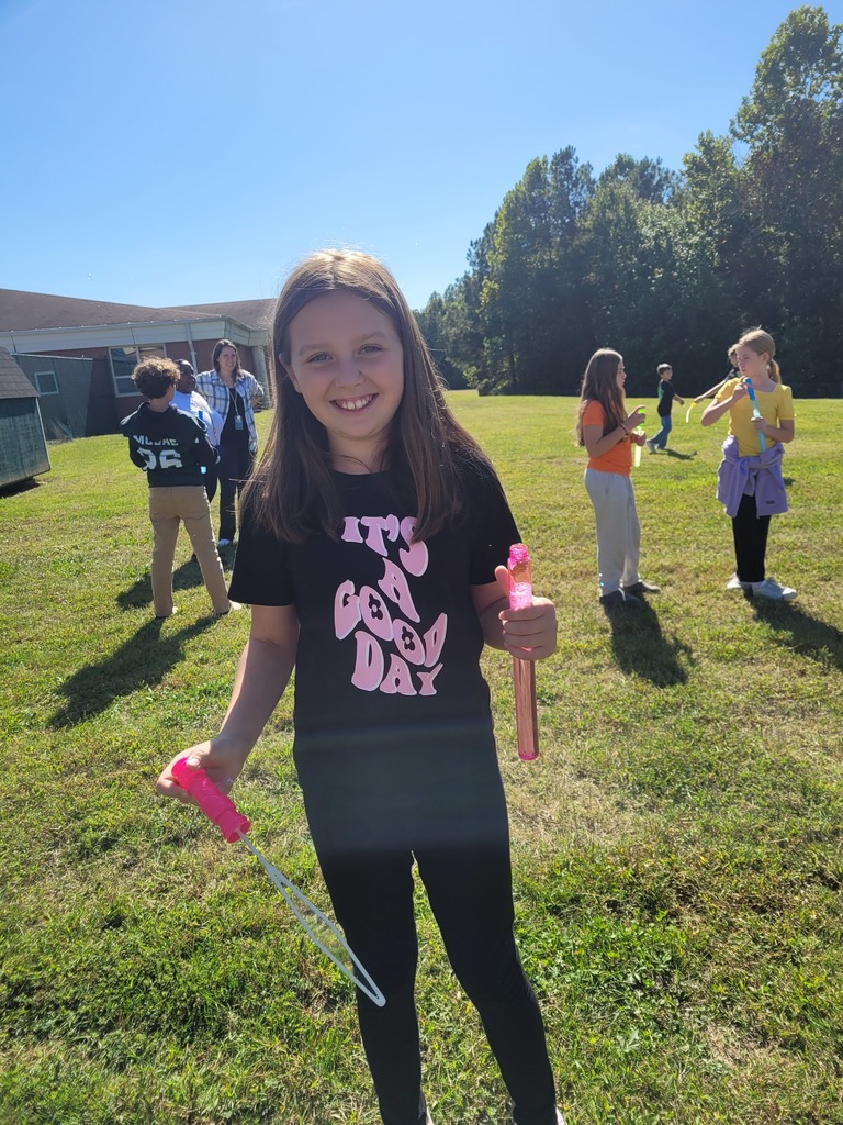 Students enjoying a bubble party for being responsible in class.