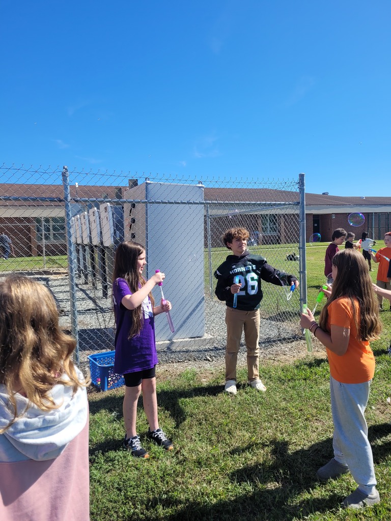 Students enjoying a bubble party for being responsible in class.