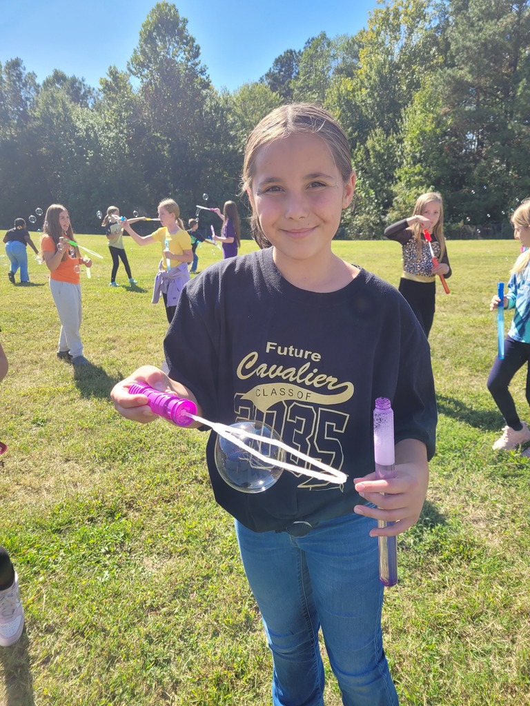 Students enjoying a bubble party for being responsible in class.
