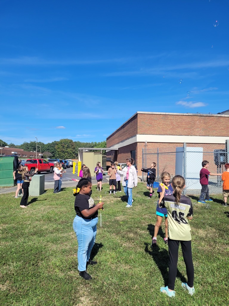 Students enjoying a bubble party for being responsible in class.