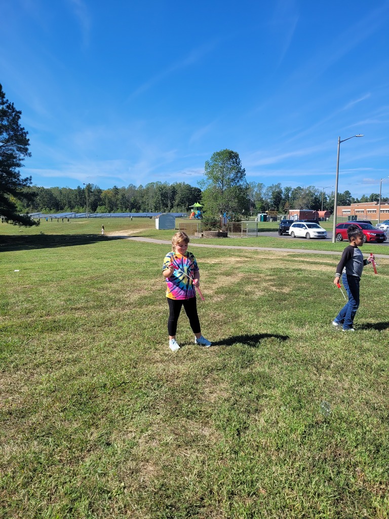 Students enjoying a bubble party for being responsible in class.