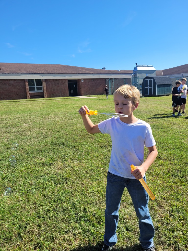 Students enjoying a bubble party for being responsible in class.