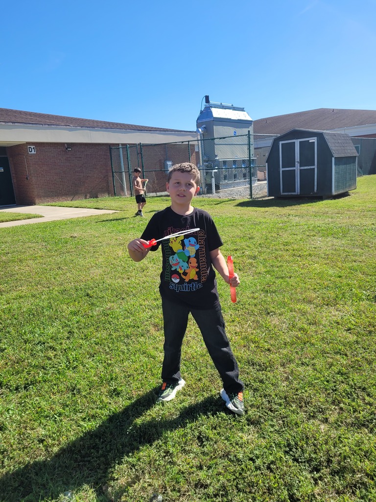 Students enjoying a bubble party for being responsible in class.