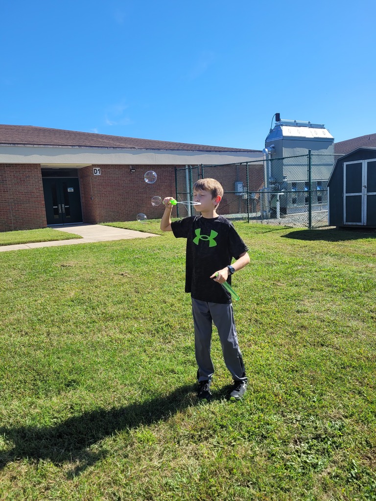 Students enjoying a bubble party for being responsible in class.