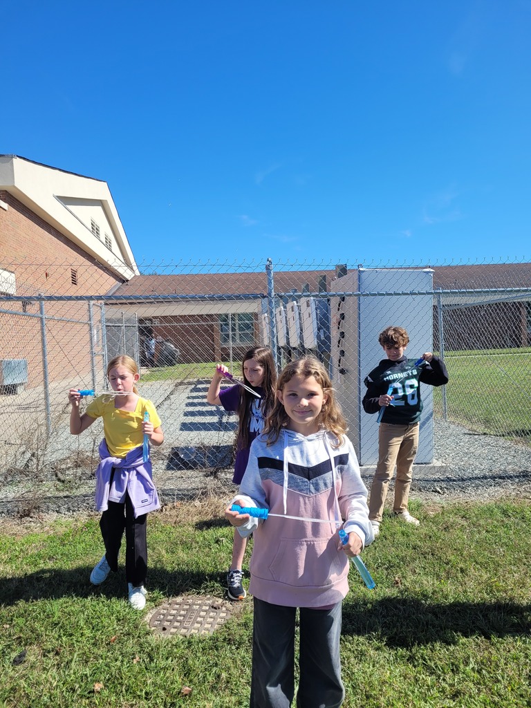 Students enjoying a bubble party for being responsible in class.
