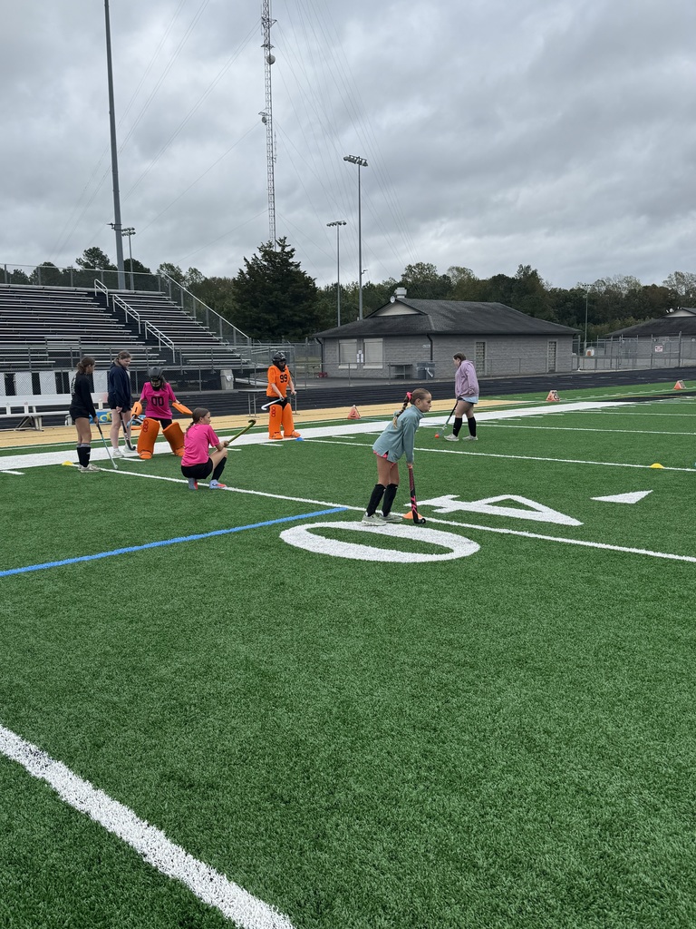 Field Hockey camp players learning skills