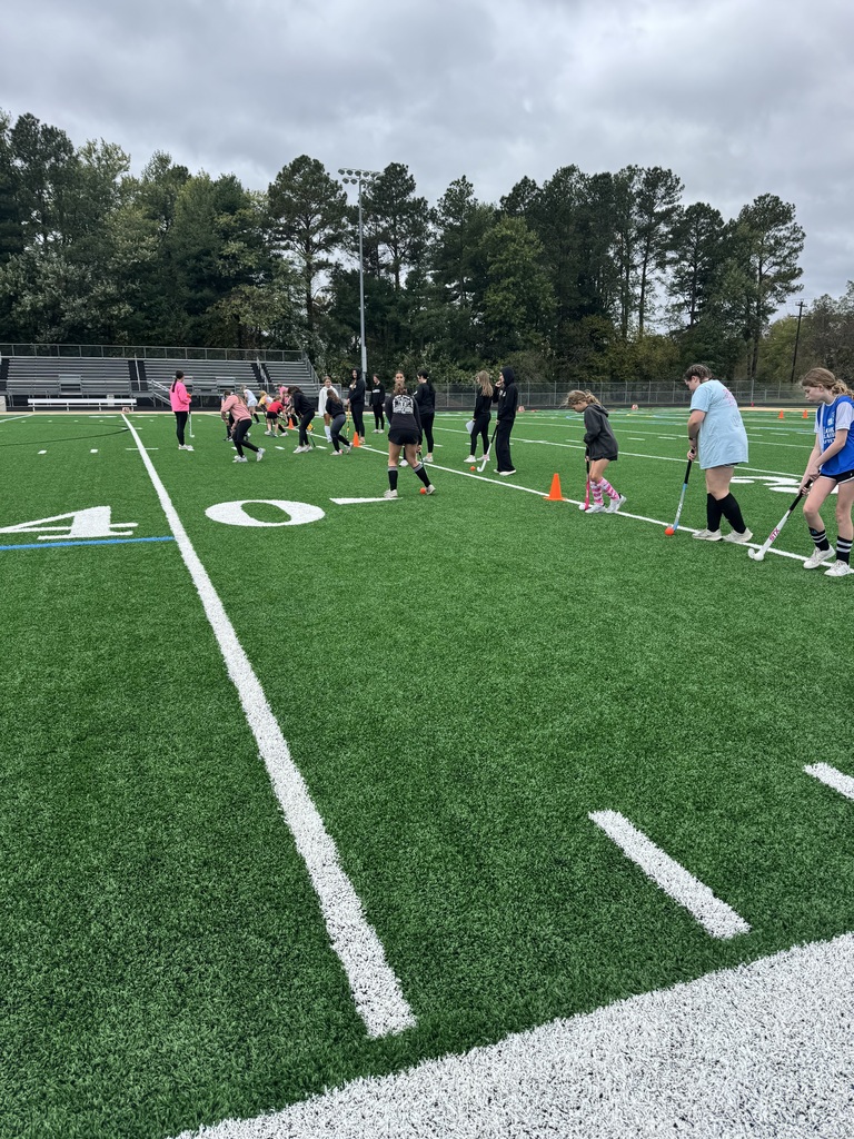 Field Hockey camp players learning skills