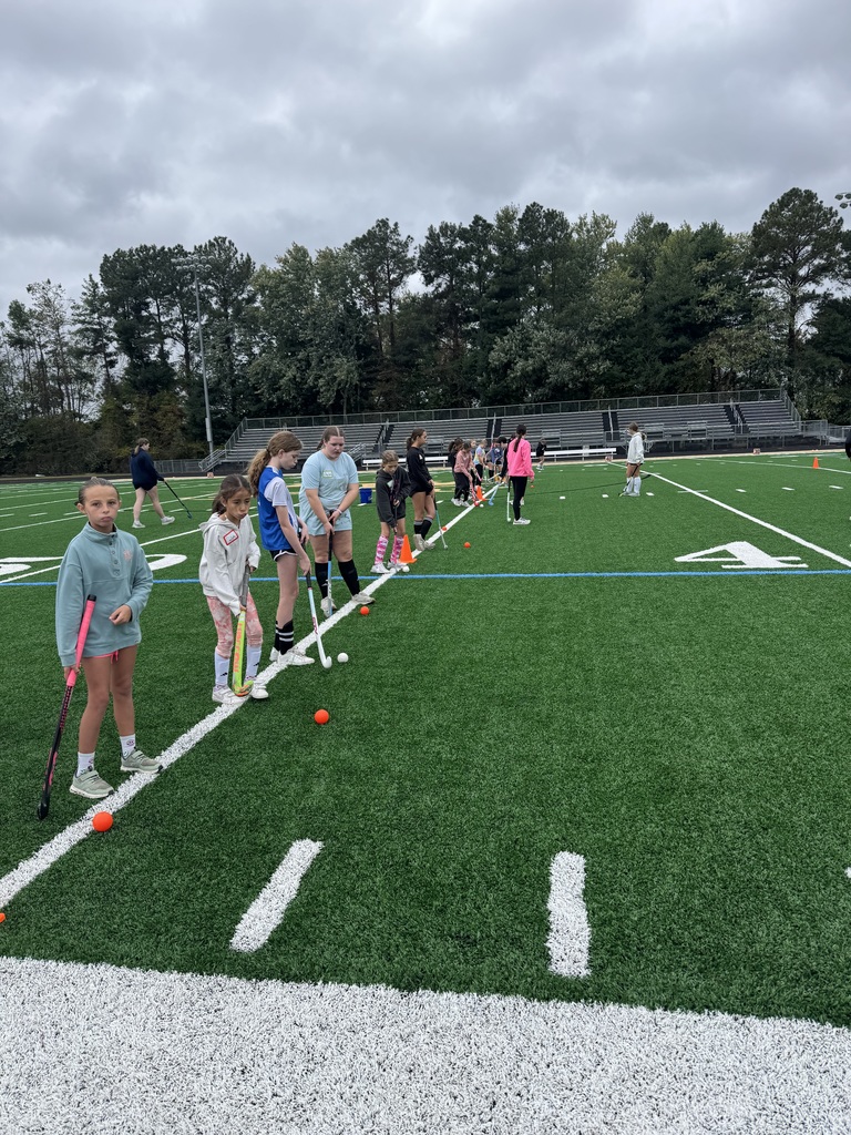 Field Hockey camp players learning skills