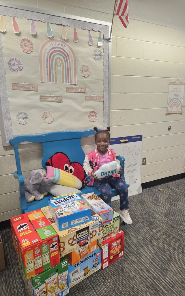 A student sitting with a large donation of snacks