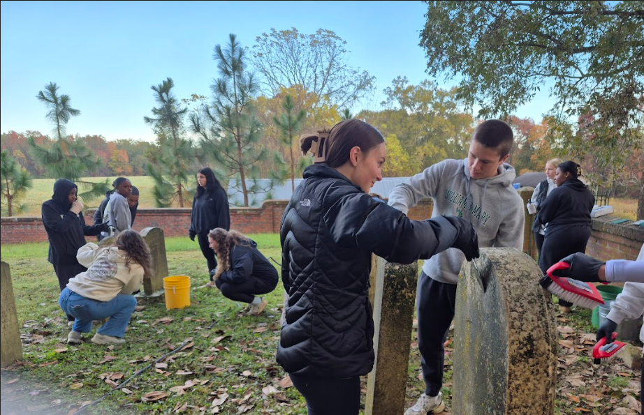 NHS students cleaning the headstones.
