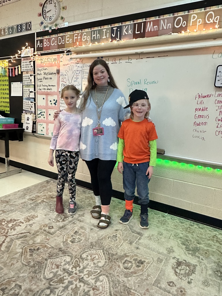 Teacher and 2 students in mix-matched outfits for Red Ribbon Week