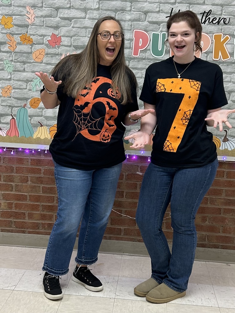 2 Teachers wearing Halloween tshirts that say 6-7