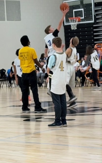 Basketball players at the tip off