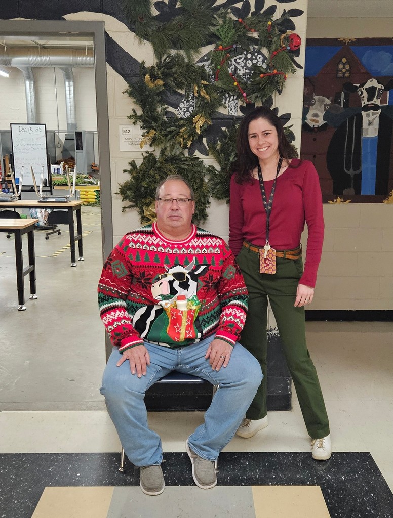 Mr. Hill and Mrs. O'Keefe standing in front of the wreaths students made