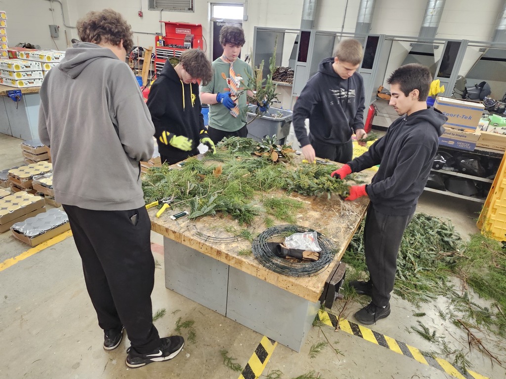 Students making wreaths out of evergreens
