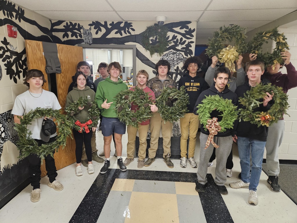 Students and the greenery wreaths they created