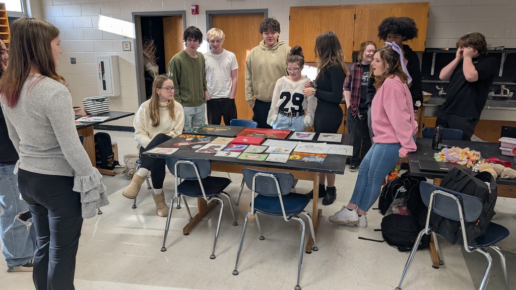 Art students exchanging pieces of work through Secret Santa exchange