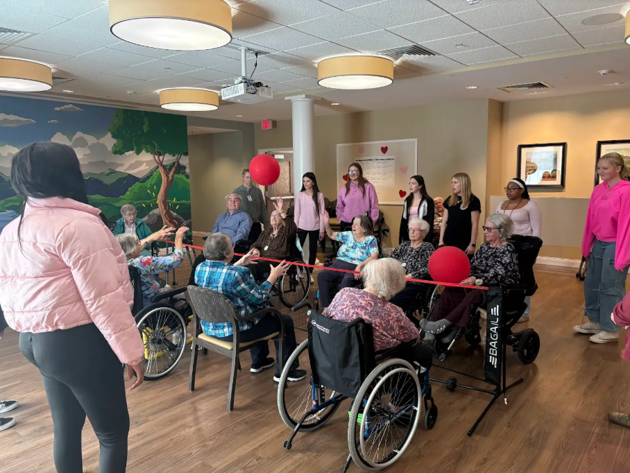 Service Learning students help celebrate Valentines Day playing volleyball with Covenant Woods residents
