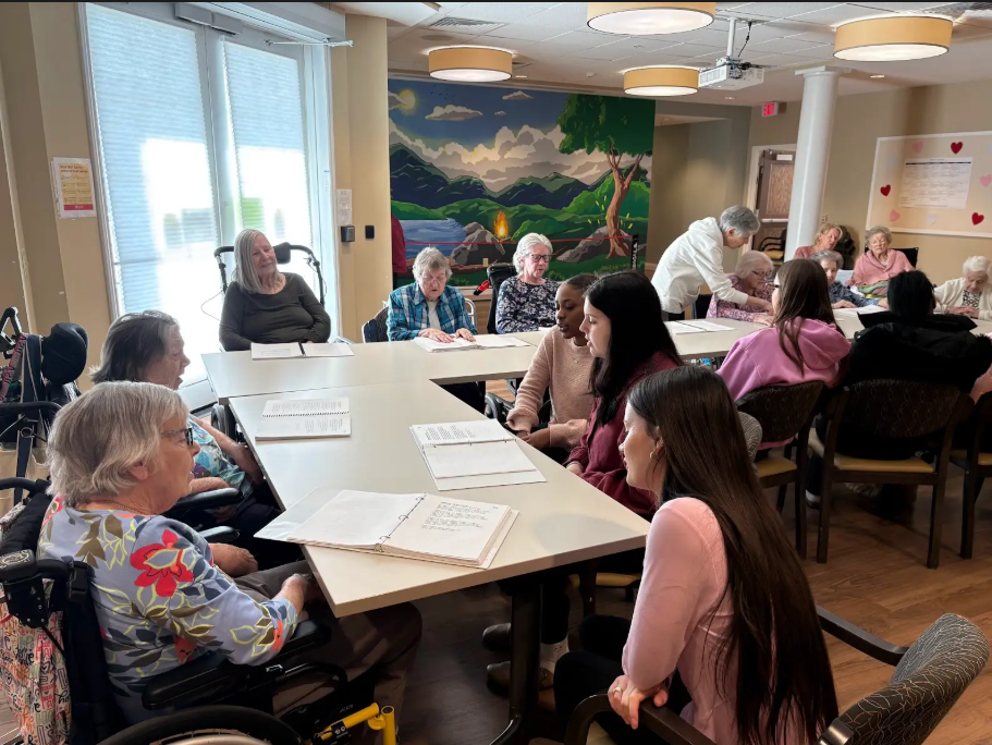 Service Learning students help celebrate Valentines Day singing songs with Covenant Woods residents