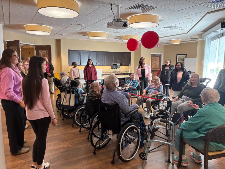Service Learning students help celebrate Valentines Day playing volleyball with Covenant Woods residents