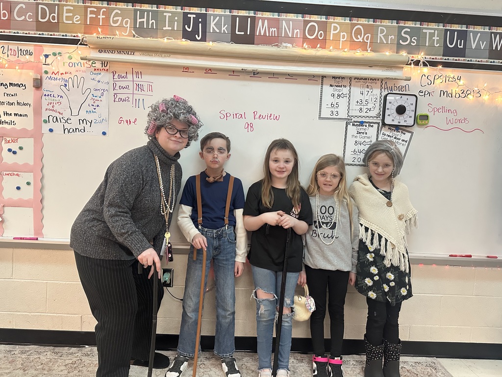 Teacher and students dressed for the 100th day of school.