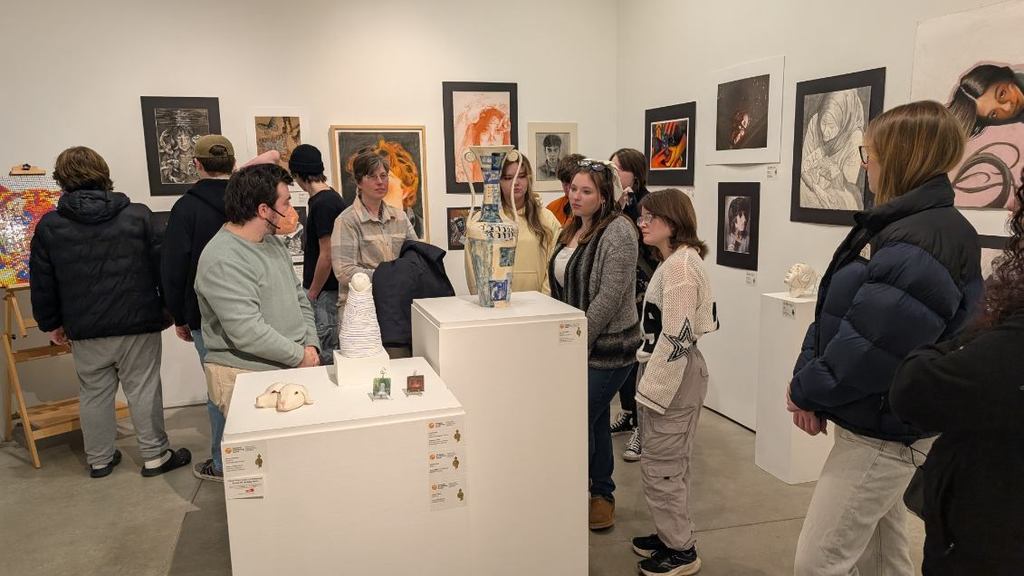Students looking at pottery work at the Visual Arts Center