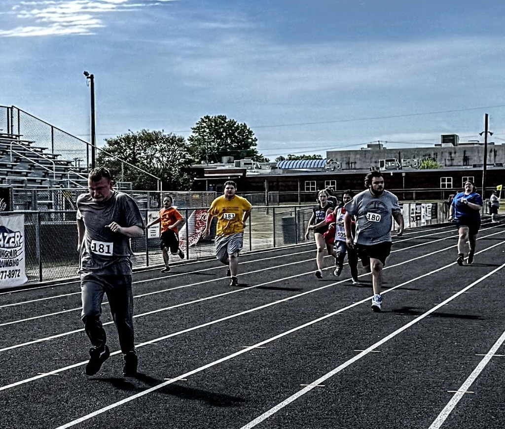 7 student runners in competition on the track