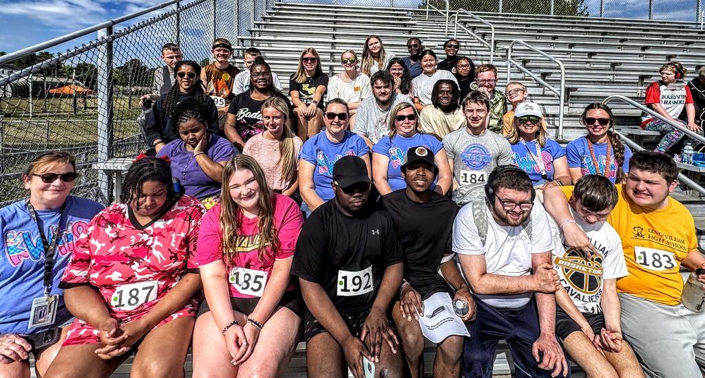 All of the participants sitting together in the bleachers