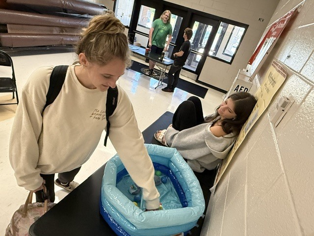Students playing game of chance duck picking carnival game