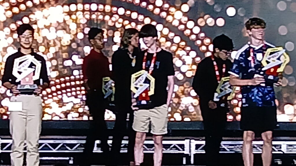 Silas on stage recieving his award 
