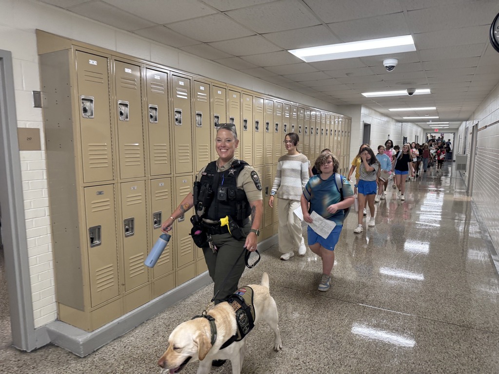 Deputy Connors and Kip escorting showing new sixth graders to their classroom 