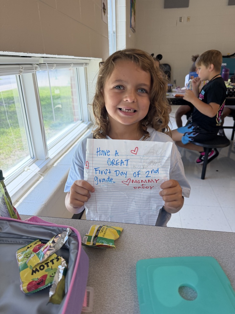 Student holding a lunch note from home.