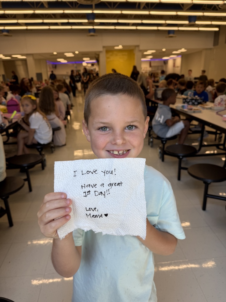 Student holding a lunch note from home.