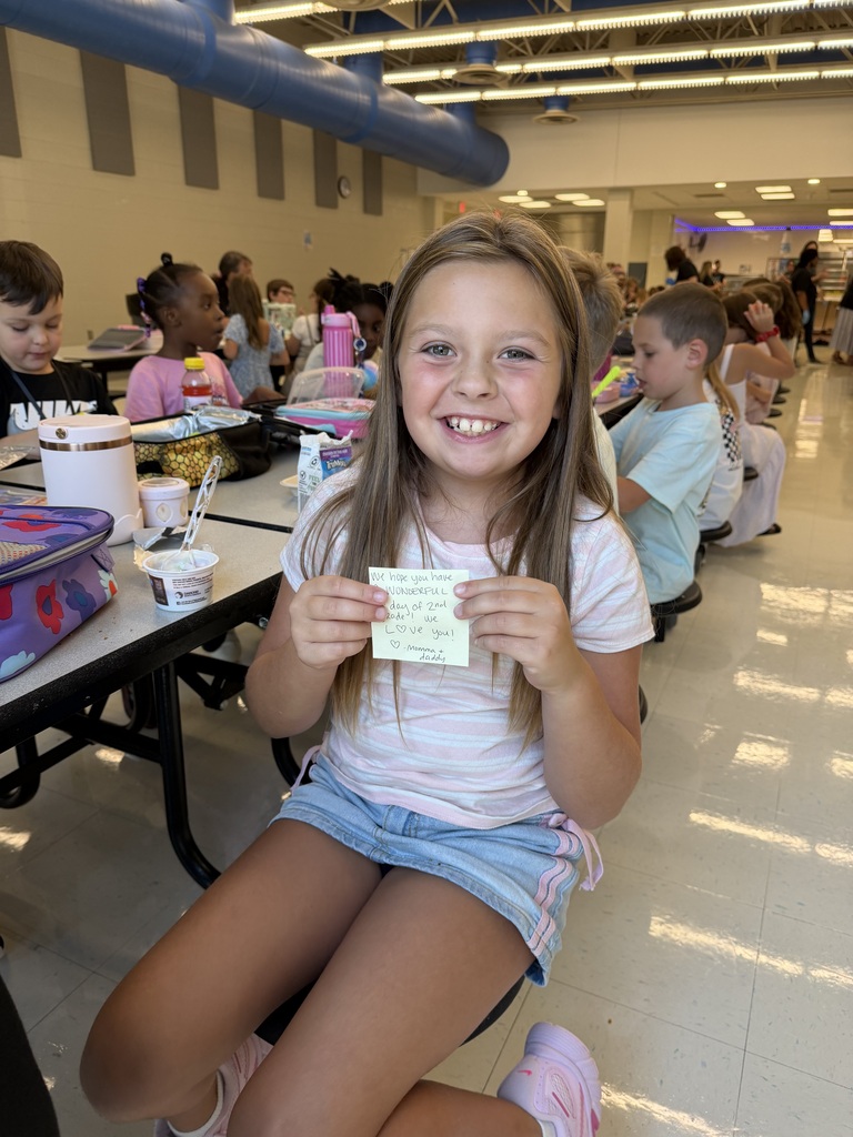 Student holding a lunch note from home.