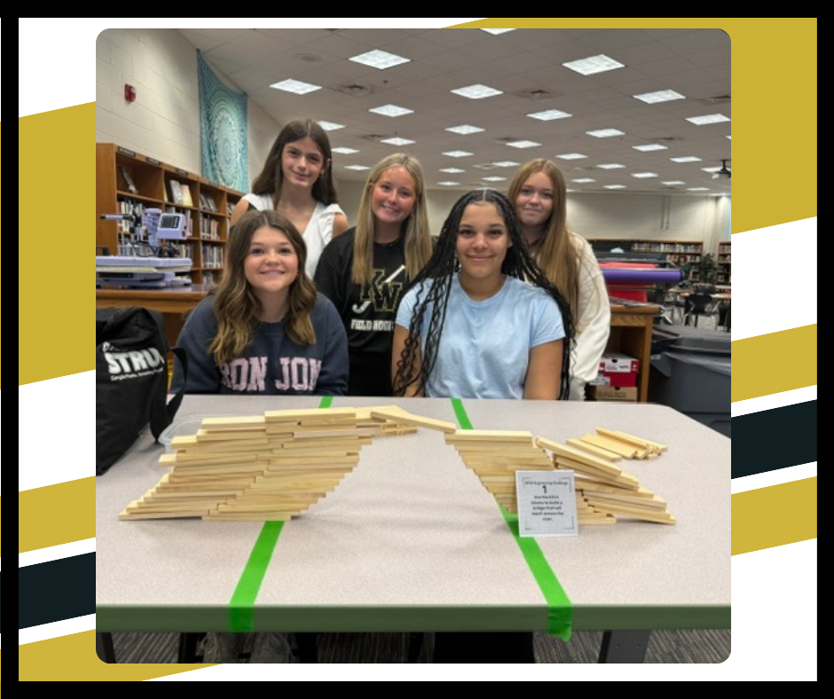 Students building a bridge with Keva blocks