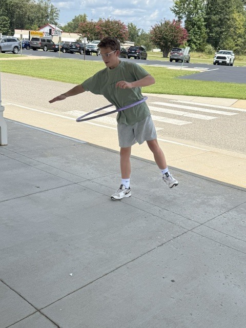 Hula hoop experiment -  student on one leg