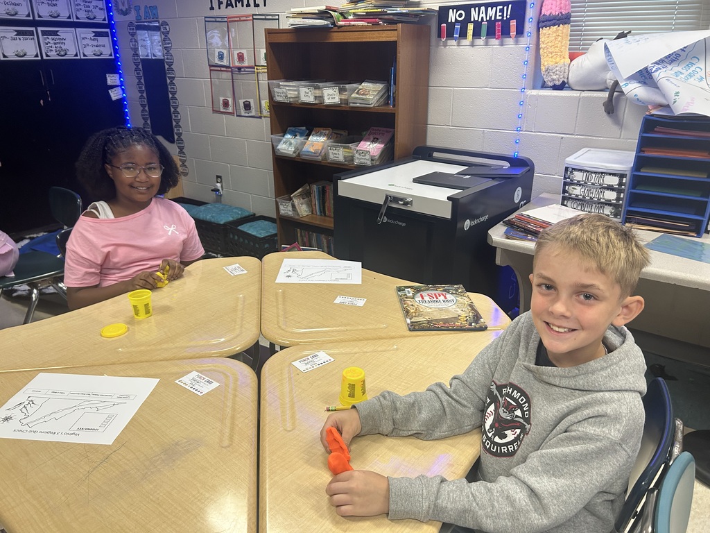 Students creating topography models out of play-doh.