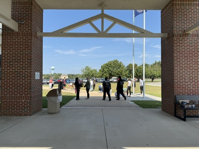 Students drawing positive messages on the sidewalk