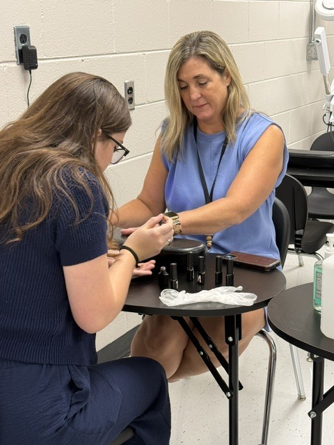 Student doing nails of client