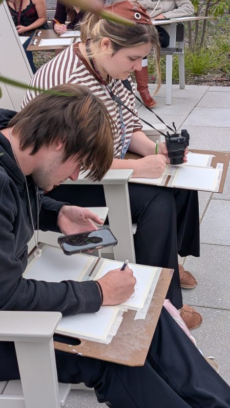 Students sketching alejibres scultures in the garden