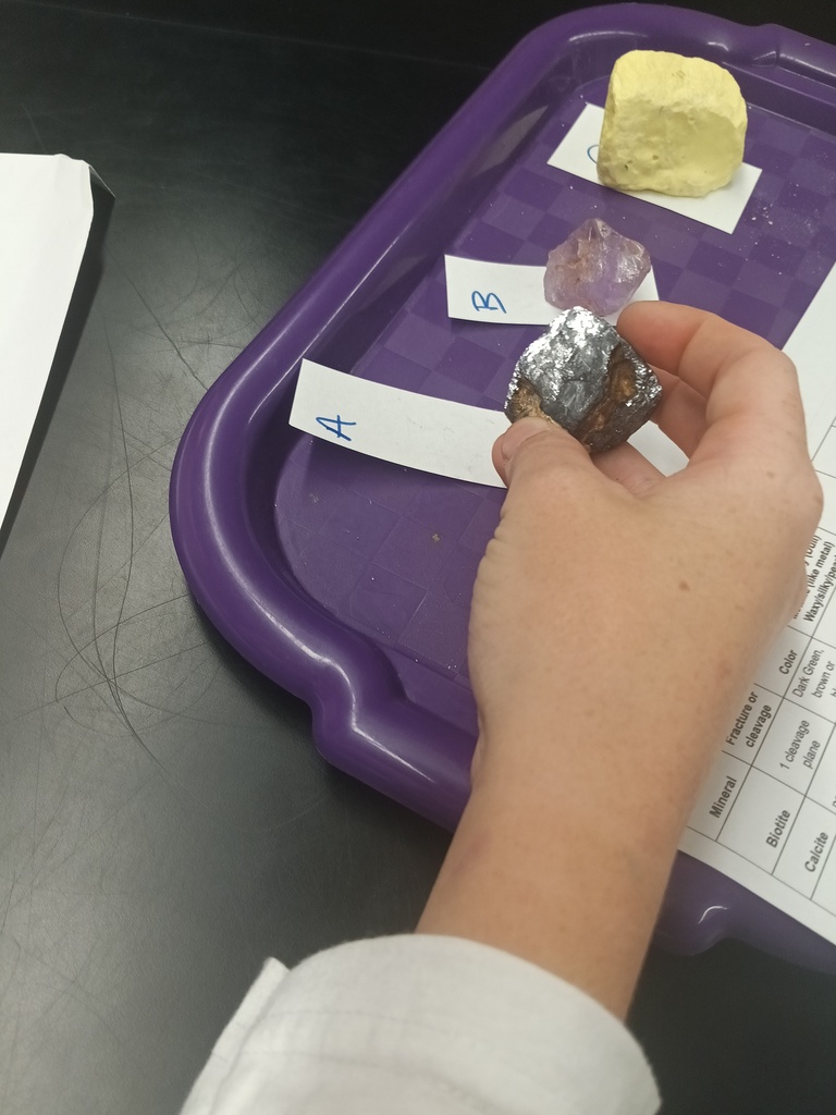 Students conducting a lab on the properties of minerals