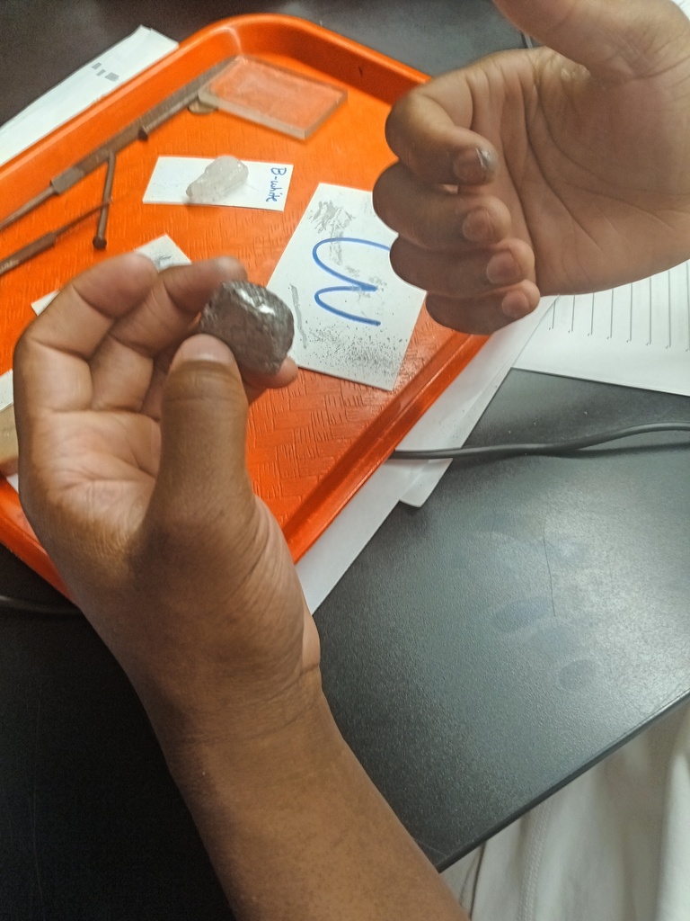 Students conducting a lab on the properties of minerals