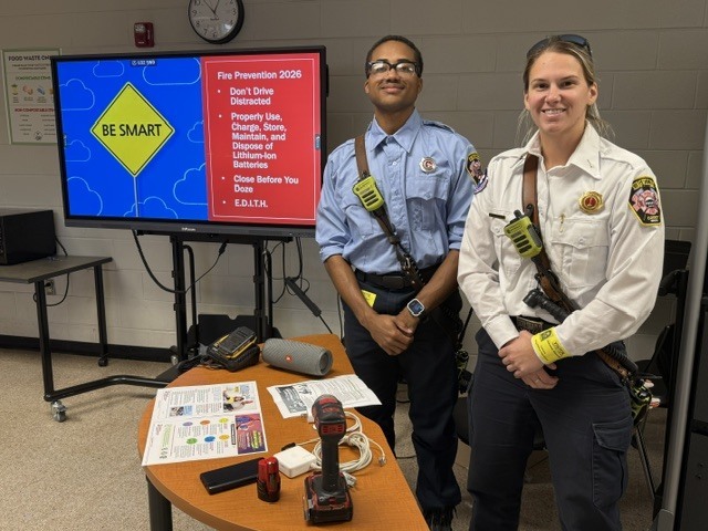Firefighters sharing safety information about batteries
