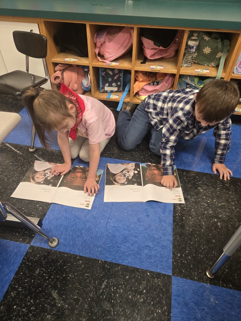 Two students reading to each other.